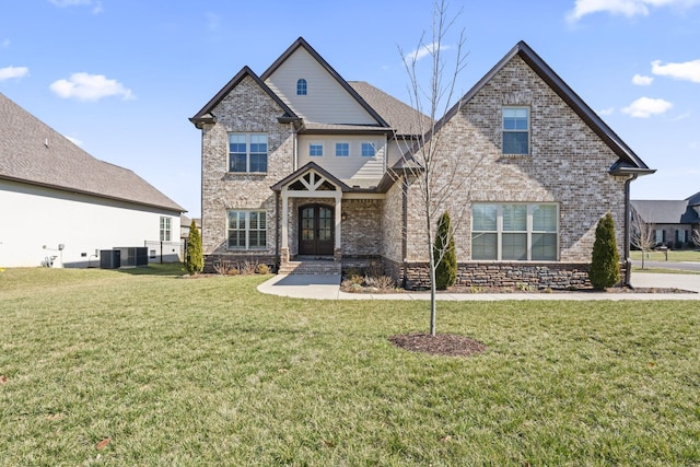 craftsman-style house featuring cooling unit, a front lawn, french doors, and brick siding