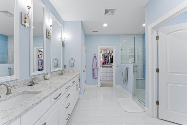 bathroom with a shower stall, visible vents, and a sink