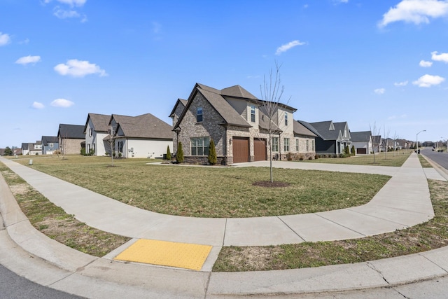 view of front of house with stone siding, driveway, a front yard, and a residential view