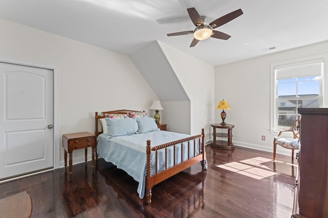 bedroom with baseboards, visible vents, ceiling fan, and wood finished floors