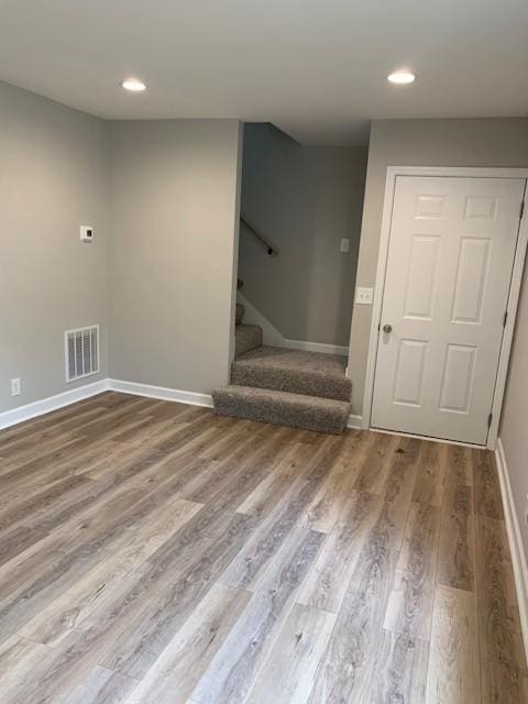 interior space with recessed lighting, wood finished floors, visible vents, baseboards, and stairs