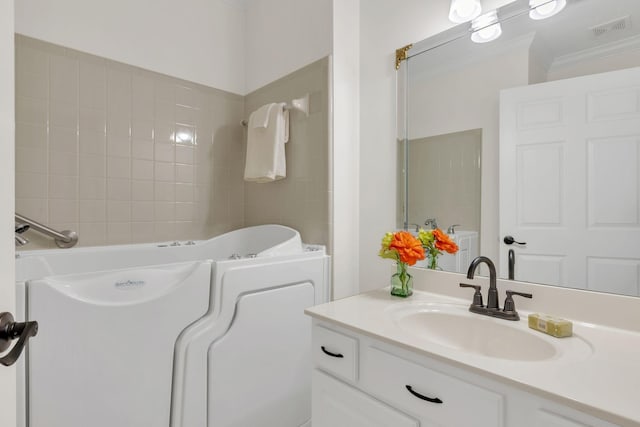 full bath with ornamental molding, visible vents, a tub to relax in, and vanity