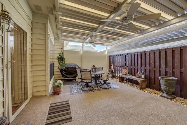 view of patio featuring outdoor dining space and fence