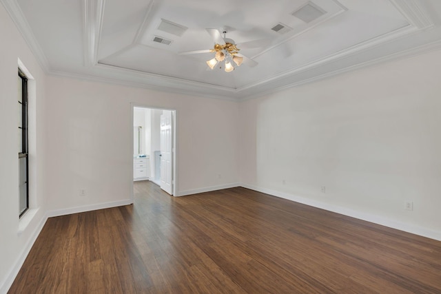 unfurnished room with visible vents, a raised ceiling, ceiling fan, dark wood-style flooring, and crown molding