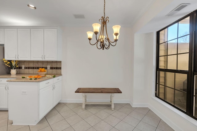 kitchen featuring light tile patterned floors, backsplash, visible vents, and white cabinetry