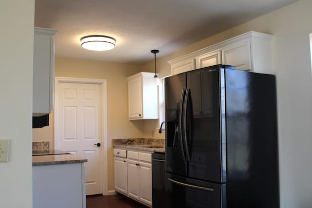 kitchen featuring black appliances, white cabinetry, a sink, and decorative light fixtures