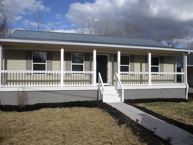 view of front of property with covered porch and metal roof