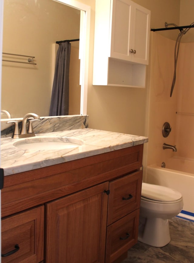 bathroom featuring toilet, shower / bath combo with shower curtain, and vanity