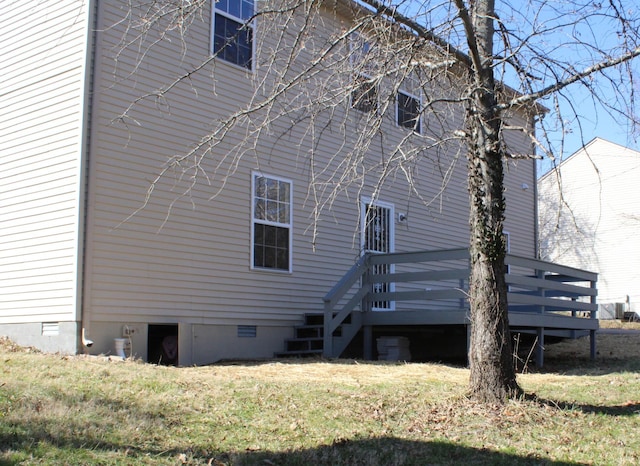 back of house featuring a deck, a yard, and crawl space