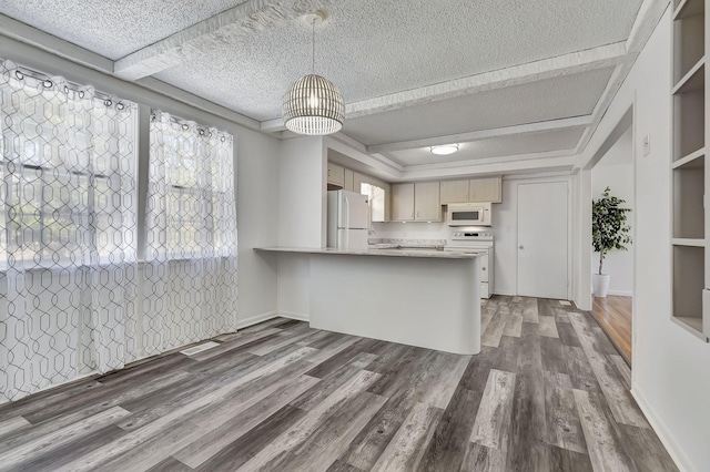 kitchen featuring a textured ceiling, a peninsula, white appliances, wood finished floors, and light countertops