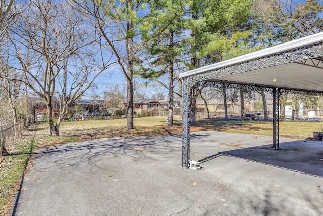 view of patio with fence, aphalt driveway, and a carport