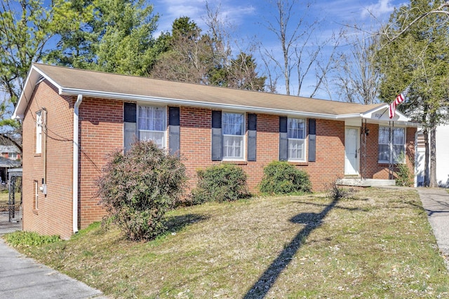 ranch-style house with brick siding and a front lawn