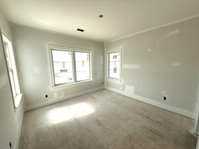 spare room featuring baseboards and ornamental molding