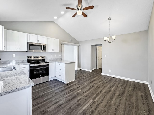 kitchen featuring light stone counters, a sink, white cabinets, appliances with stainless steel finishes, and dark wood finished floors