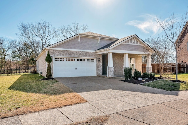 craftsman-style house featuring concrete driveway, fence, a front lawn, and an attached garage