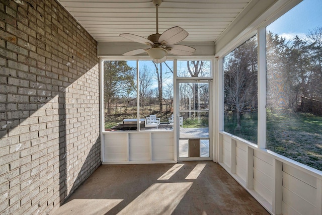 unfurnished sunroom with a ceiling fan