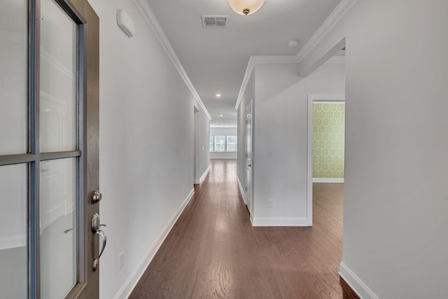 hallway featuring recessed lighting, visible vents, ornamental molding, wood finished floors, and baseboards