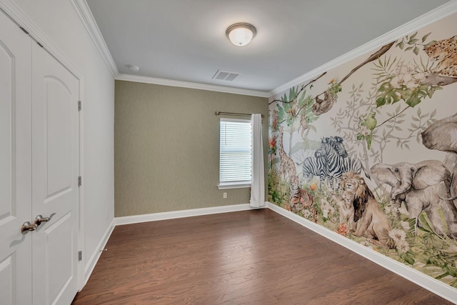 unfurnished room featuring wallpapered walls, baseboards, visible vents, ornamental molding, and dark wood-style flooring