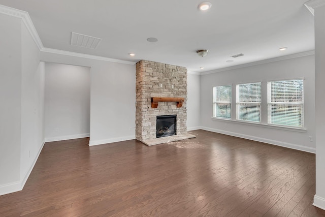 unfurnished living room featuring dark wood-style floors, a stone fireplace, ornamental molding, and baseboards