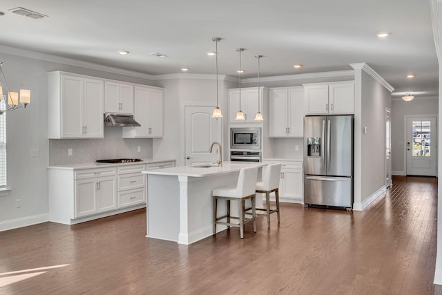 kitchen featuring stainless steel appliances, light countertops, visible vents, and under cabinet range hood