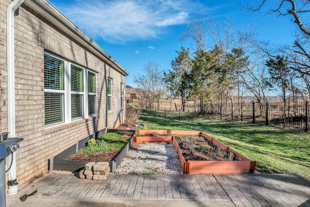 view of yard with a vegetable garden and fence