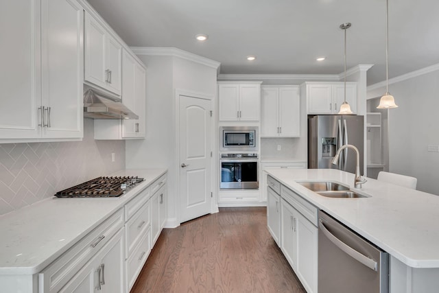 kitchen featuring under cabinet range hood, stainless steel appliances, dark wood-type flooring, a sink, and white cabinetry