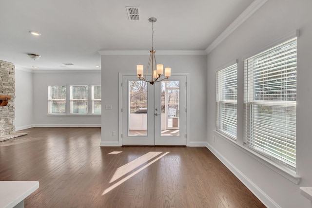 doorway featuring ornamental molding, dark wood-type flooring, visible vents, and baseboards