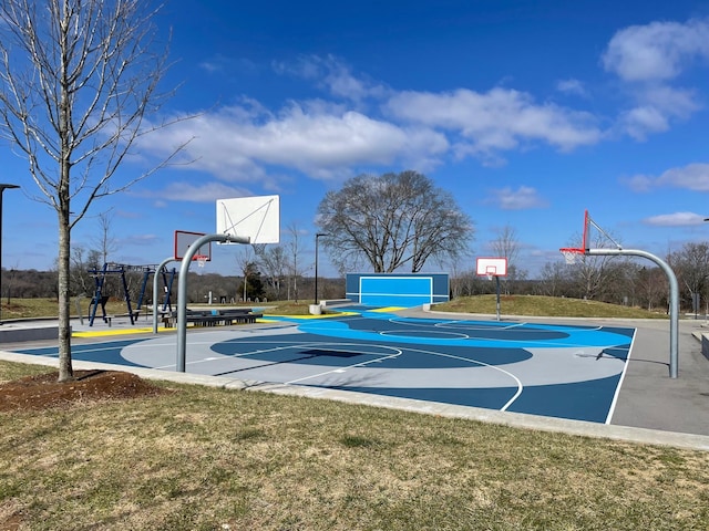 view of basketball court with community basketball court and a lawn