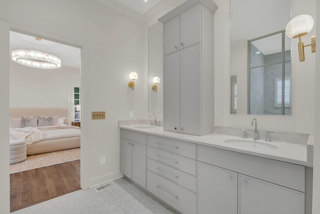 ensuite bathroom featuring connected bathroom, visible vents, a sink, and double vanity