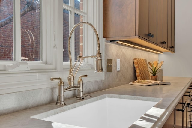 interior details with tasteful backsplash and a sink