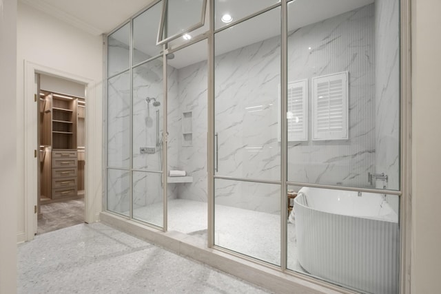 full bathroom with a walk in closet, a soaking tub, a marble finish shower, and speckled floor