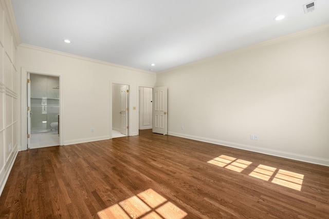 unfurnished bedroom with ensuite bathroom, wood finished floors, visible vents, and crown molding