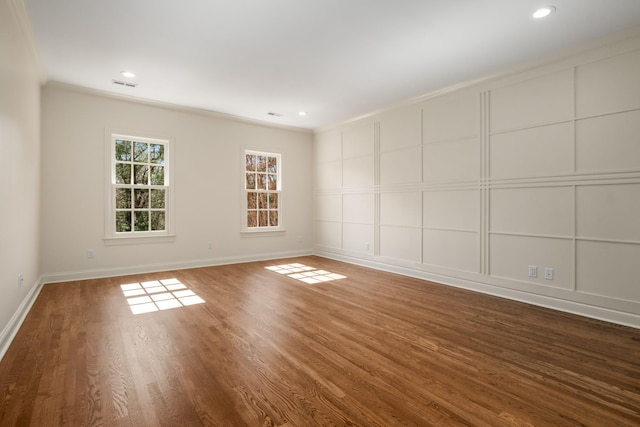 empty room with baseboards, visible vents, wood finished floors, and recessed lighting