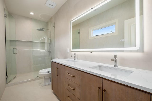 full bathroom with a stall shower, a sink, and toilet