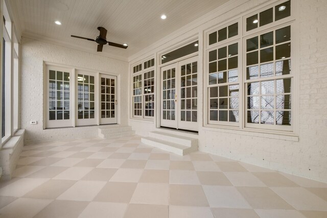 unfurnished sunroom with wooden ceiling and ceiling fan