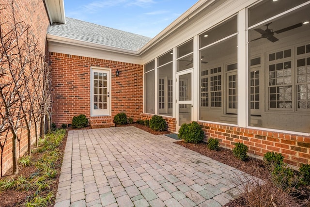 view of patio / terrace featuring entry steps, a sunroom, and ceiling fan