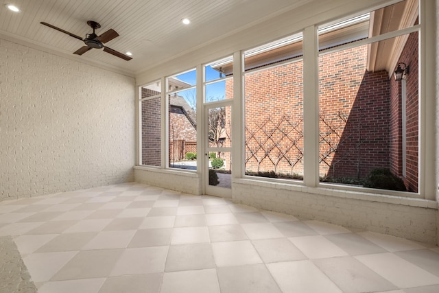 unfurnished sunroom featuring ceiling fan and wood ceiling