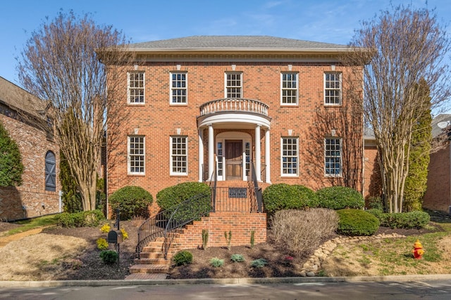 colonial-style house featuring brick siding