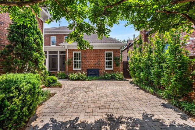 53 Whitworth Blvd, Nashville, TN 37205 - view of front facade with brick siding, a sunroom, and a shingled roof