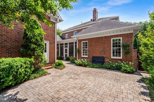 53 Whitworth Blvd, Nashville, TN 37205 - back of house with a sunroom, brick siding, a shingled roof, and a patio area