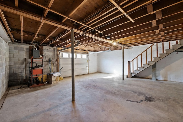 basement featuring electric panel and stairs