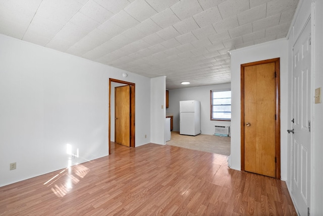 unfurnished living room featuring light wood-type flooring