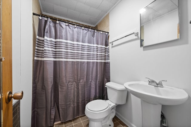 bathroom featuring curtained shower, tile patterned flooring, and toilet