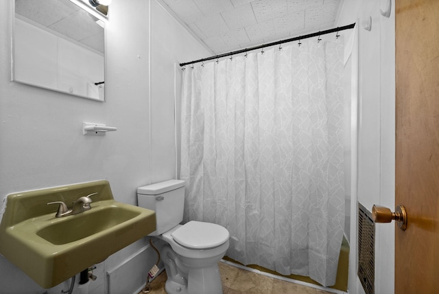 full bathroom with a sink, toilet, and shower / bath combo with shower curtain