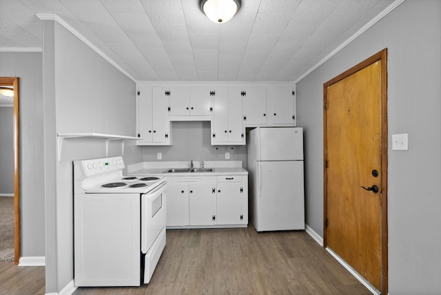 kitchen featuring ornamental molding, white appliances, white cabinetry, and a sink