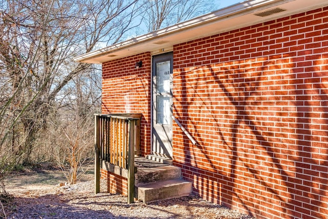 entrance to property with brick siding