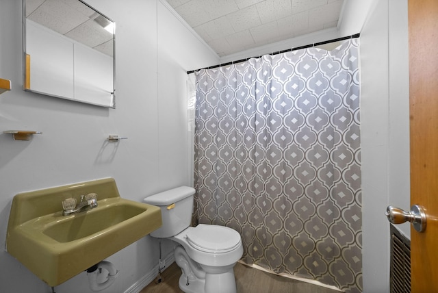 full bathroom with toilet, a shower with curtain, a sink, and wood finished floors