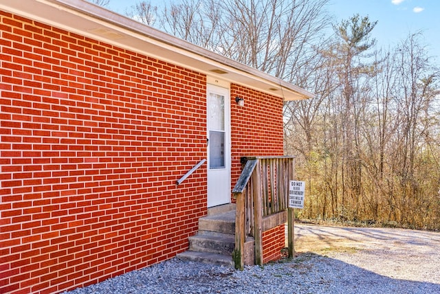 property entrance featuring brick siding