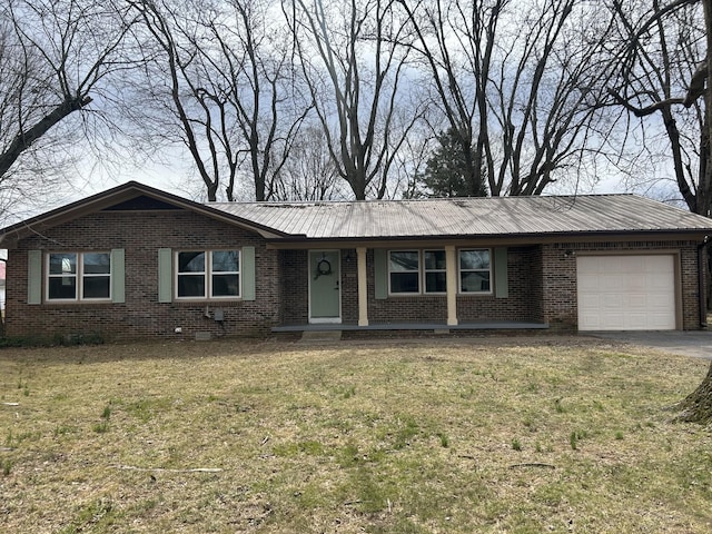 ranch-style home featuring metal roof, brick siding, and an attached garage