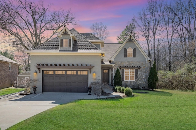 view of front of home featuring a garage, brick siding, a yard, and driveway